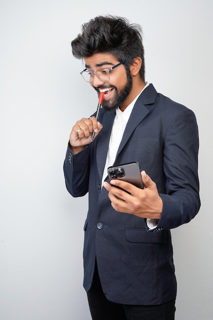 Businessman hand holding mobile phone and marker standing\
isolated on white background man in suit writing using phone\
thinking video call conversation