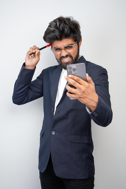 Businessman hand holding mobile phone and marker standing\
isolated on white background man in suit writing using phone\
thinking video call conversation