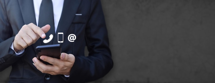 Photo businessman hand holding smartphone with icon mobile phone and email address concept of customer service call center contact contacting information on business copy space