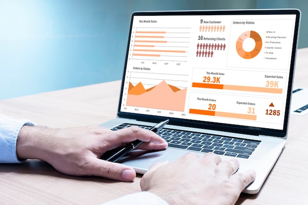 Photo businessman hand on keyboard laptop with mockup chart presentation slide show on display