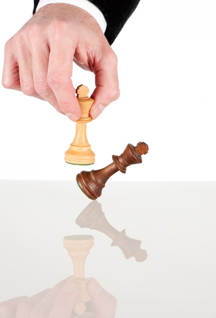 Businessman hand moving the king to win