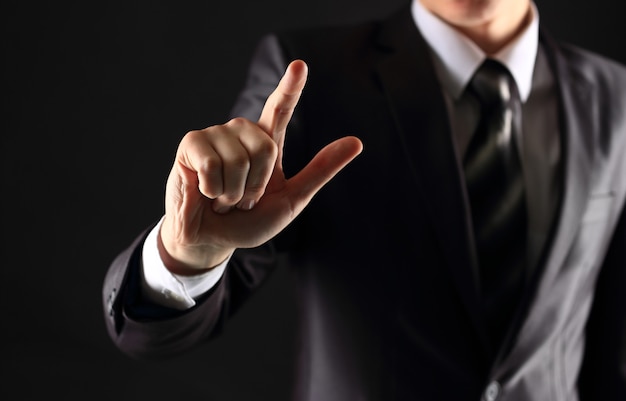 Businessman hand pressing an imaginary button on virtual screen