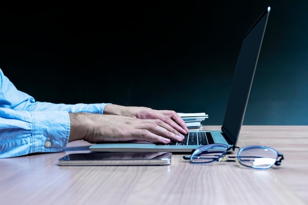 Businessman hand pressing keyboard laptop