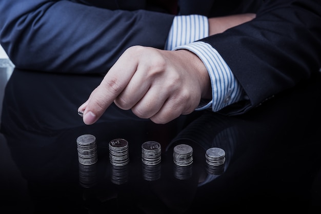 Businessman Hand Put Coins To Stack Of Coins