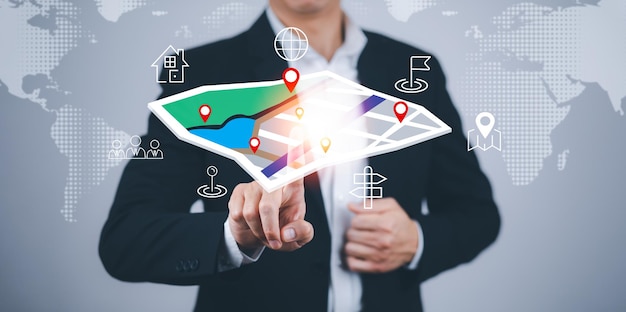 Businessman hand touch virtual world and model map with\
location point , gps app, icon travel maps and find places in the\
online system, all screen graphics are generated,searching for\
travel goals.