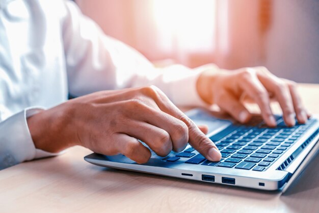 Businessman hand using laptop computer in office uds