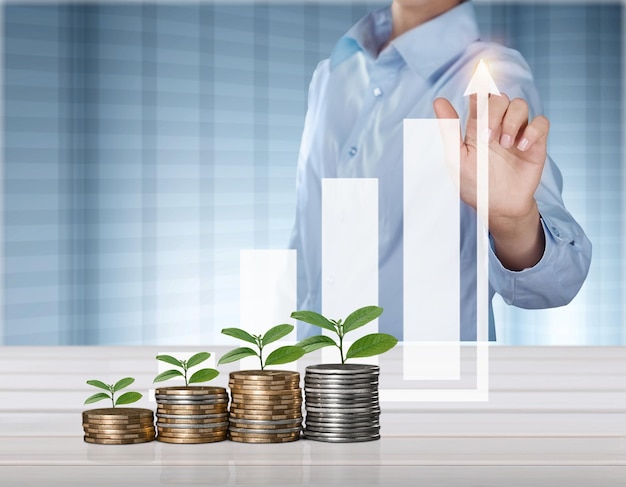 Businessman hand with financial chart and stack of coins, Business financial concept.