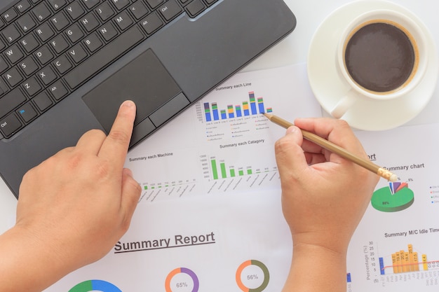 businessman hand working on laptop computer with business graph information diagram