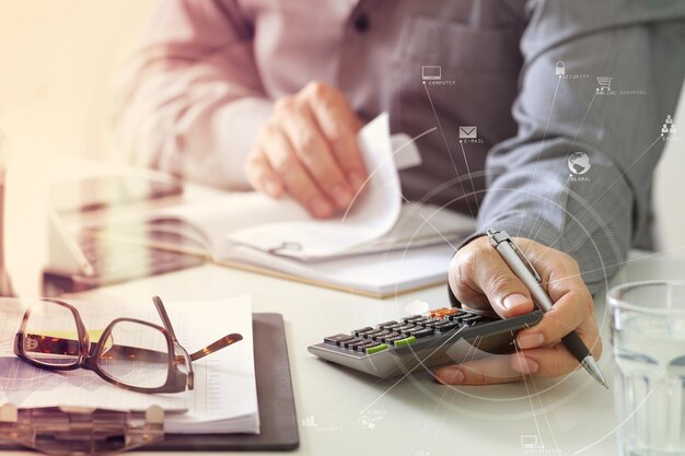 Businessman hand working with finances about cost and calculator and laptop with mobile phone