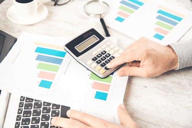 Businessman hand working with financial data and calculator