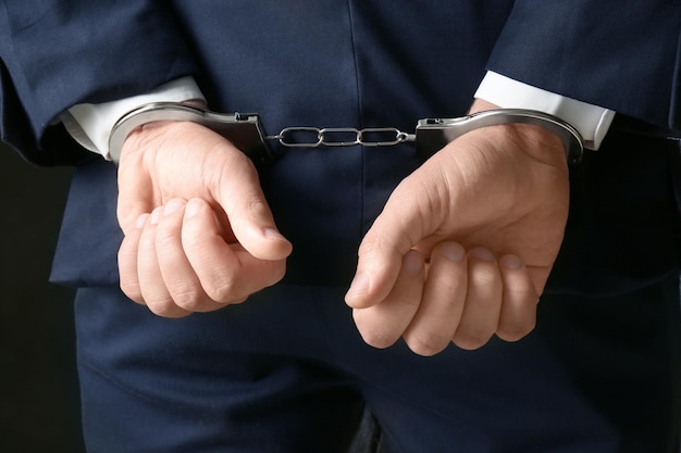 Businessman in handcuffs closeup