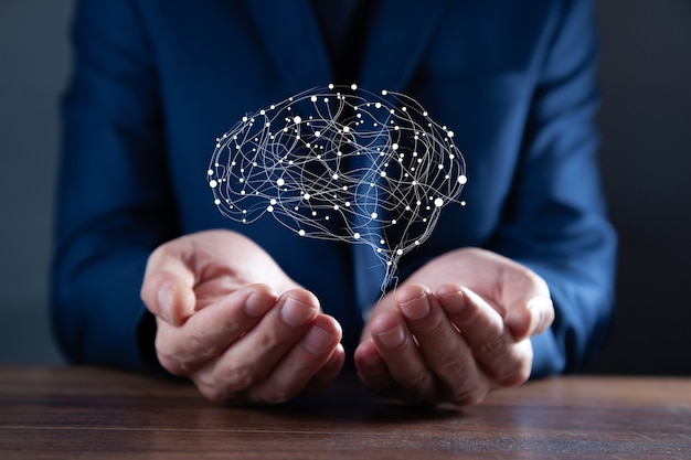 Businessman hands holding abstract polygonal brain on dark