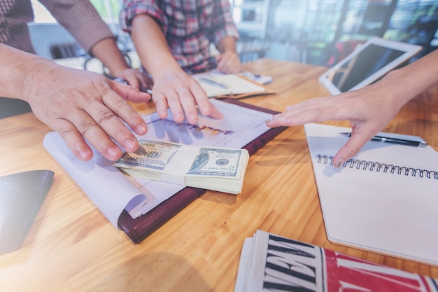 Businessman hands scramble for pick up money. Challenge concept