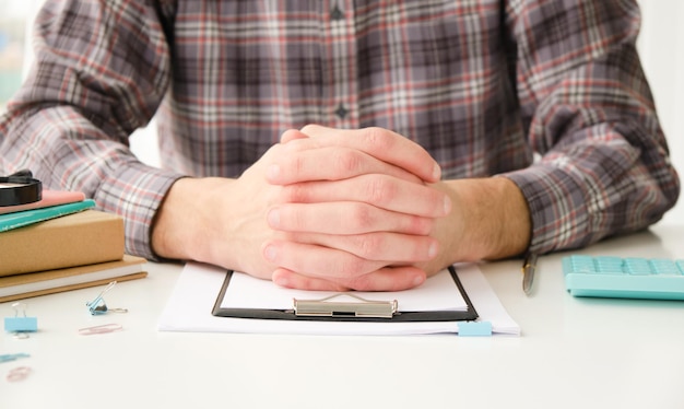 Businessman hands on the table next to the document.