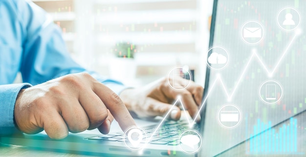 Photo businessman hands typing on a laptop keyboard stock market analysis with trading graphs concept