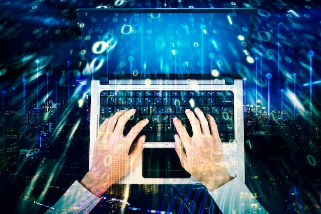businessman hands using a laptop with binary code
