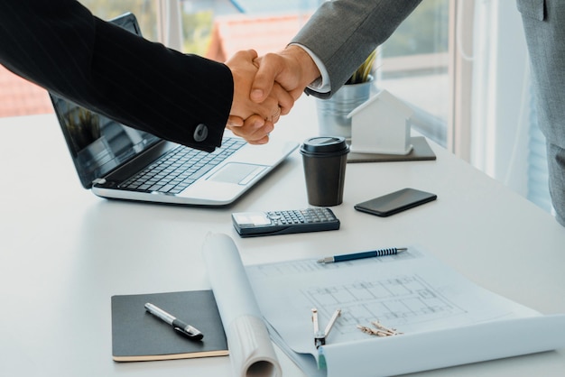 Businessman handshake businesswoman in office uds