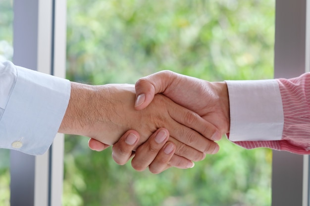 Businessman handshake at office, business cooperation, success in business concept