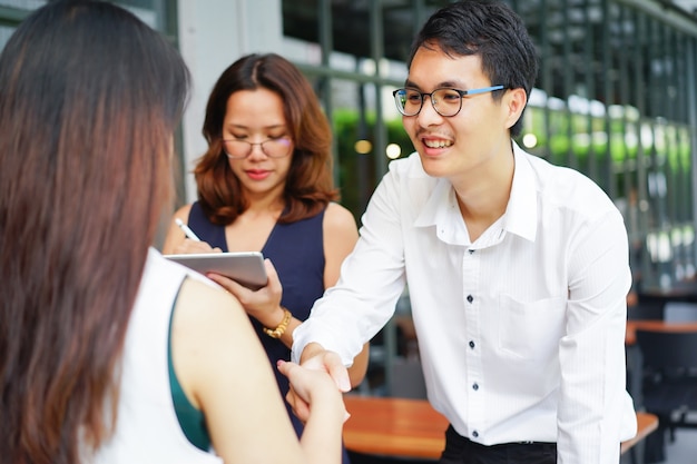 businessman handshake with businesswoman after deal successful