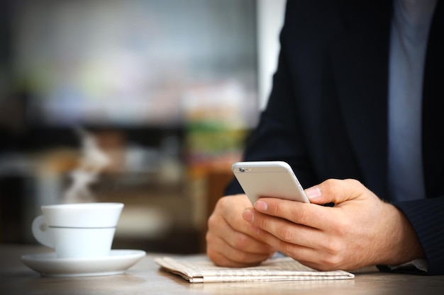 Businessman having lunch and working in a cafe closeup