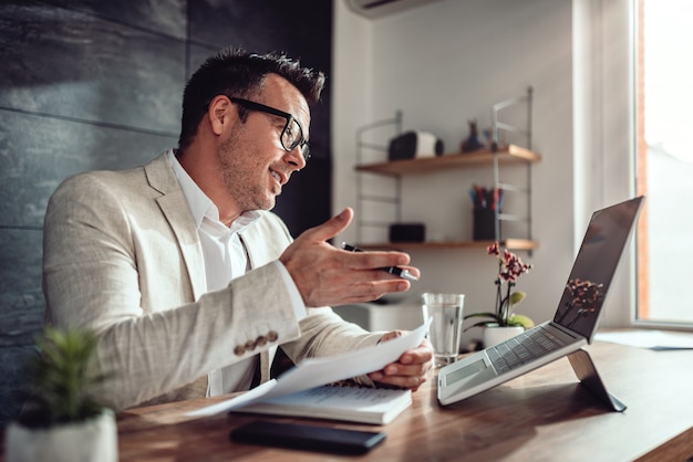 Businessman having online meeting in his office