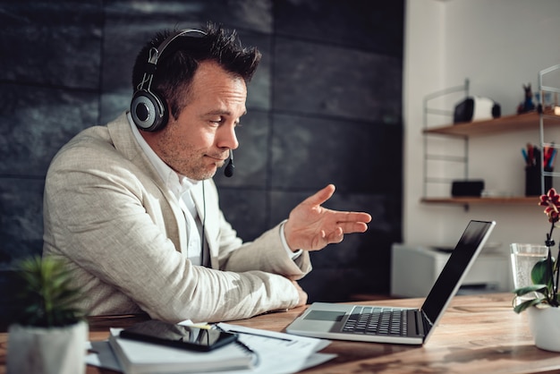 Businessman having online meeting in his office