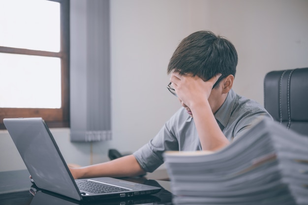 Businessman having stress with laptop computer working in the office, stress and overwork 