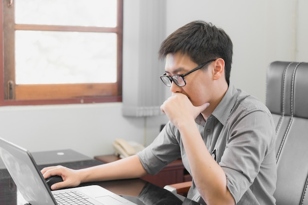 Businessman having stress with laptop computer working in the office