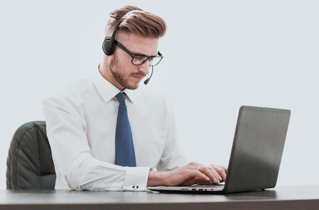 Businessman in headphones working on a laptop