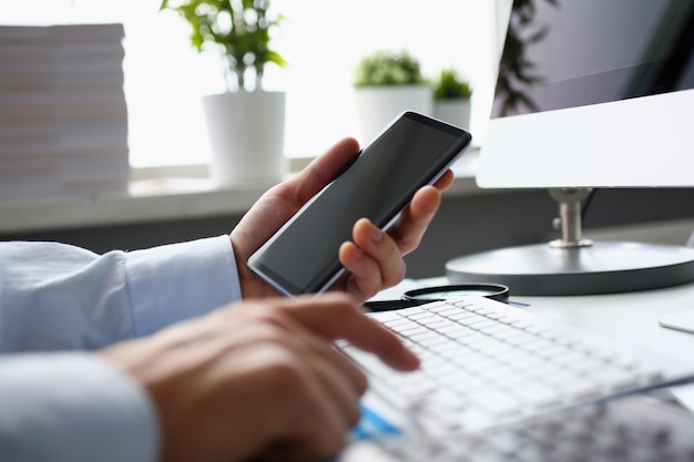 Businessman hipster holds telephone background of