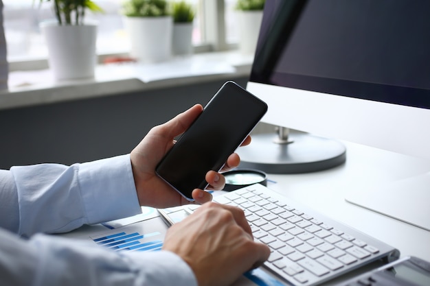 Businessman hipster holds telephone background of