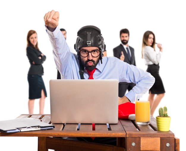 Businessman in his office with pilot hat