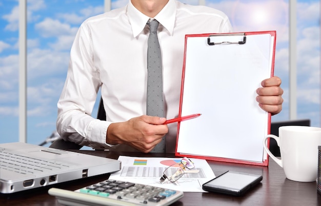 Businessman holaing blank clipboard