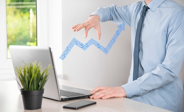 Businessman hold drawing on screen growing graph, arrow of positive growth icon.pointing at creative business chart with upward arrows.Financial, business growth concept.