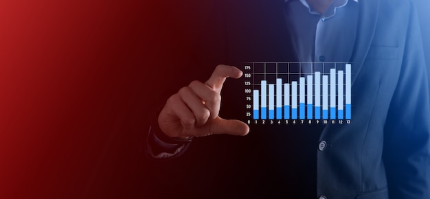 Businessman hold drawing on screen growing graph, arrow of positive growth icon.pointing at creative business chart with upward arrows.Financial, business growth concept.