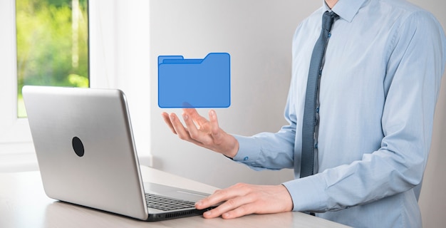 Businessman hold folder icon.document management system or dms\
setup by it consultant with modern computer are searching managing\
information and corporate files.business processing,