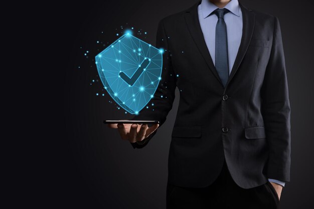 Businessman hold low poly polygon shield with a tick icon.Secure Access System Concept.Business Financial Warranty for Investment.antivirus concept.Technology security.Protection network,safe data.