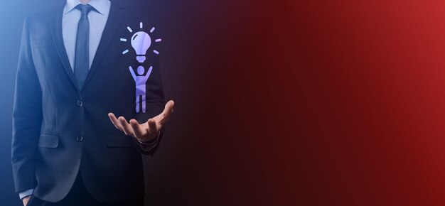 Businessman hold man icon with light bulbs, ideas of new ideas with innovative technology and creativity. concept creativity with bulbs that shine glitter.