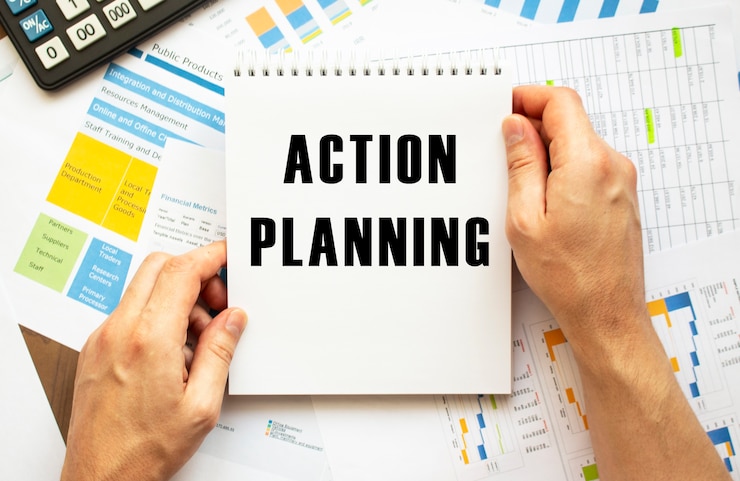 Photo businessman hold notepad with text action planning. financial charts on the desktop. financial and business concept.