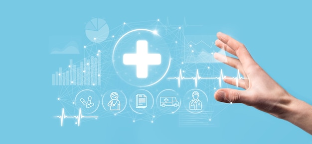 Businessman hold virtual plus medical network connection icons. Covid-19 pandemic develop people awareness and spread attention on their healthcare.Doctor,document,medicine,ambulance,patient icon.