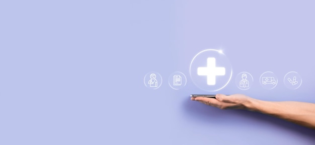 Businessman hold virtual plus medical network connection icons. Covid-19 pandemic develop people awareness and spread attention on their healthcare.Doctor,document,medicine,ambulance,patient icon.