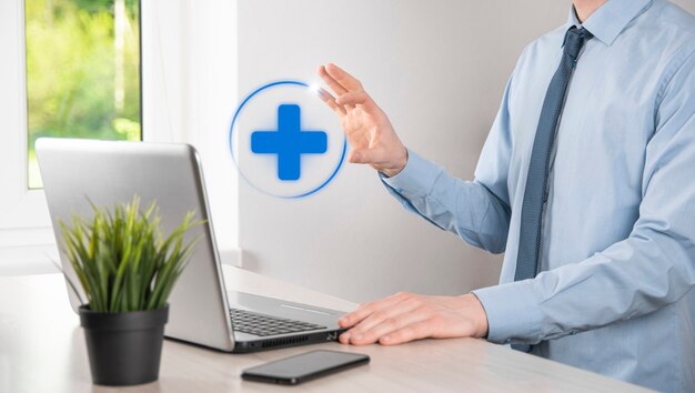 Businessman hold virtual plus medical network connection icons. Covid-19 pandemic develop people awareness and spread attention on their healthcare.