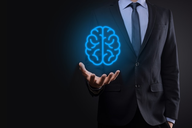 Businessman holding abstract brain and icon tools, device, customer network connection communication