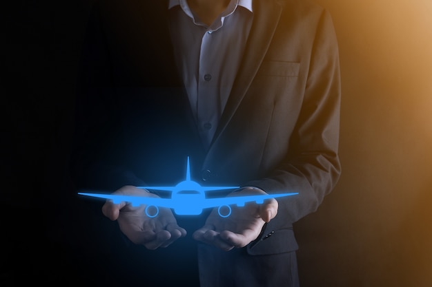 Businessman holding an airplane icon in his hands