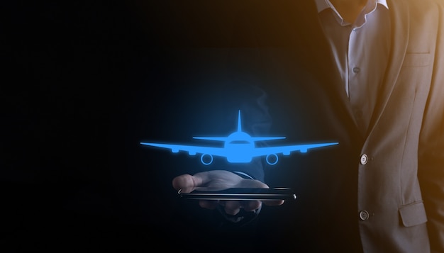 Businessman holding an airplane icon in his hands