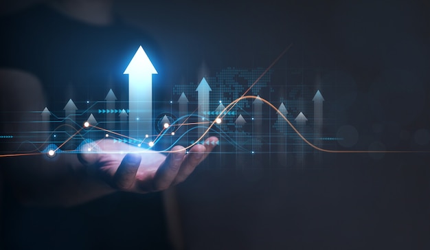 Businessman holding arrow up 
with graph of business analysis Business development financial plan and  strategy