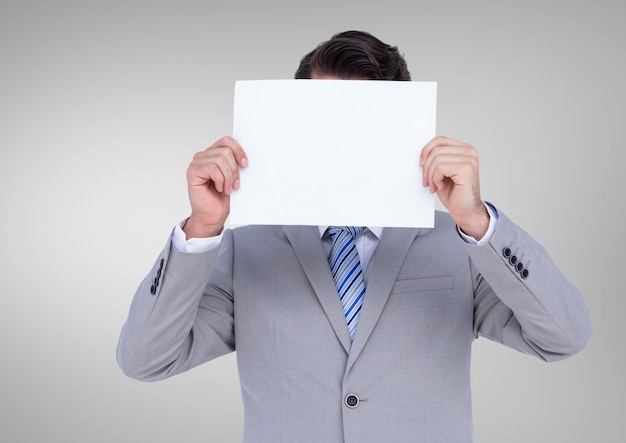 Businessman holding a blank paper in front of his face