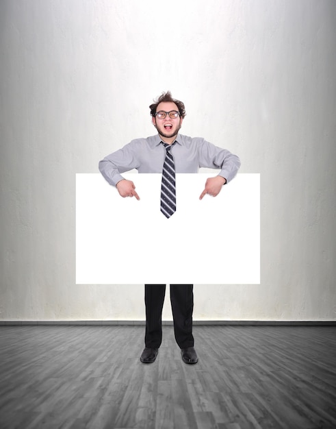 Businessman holding blank poster