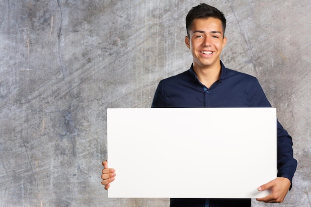 Businessman holding a blank signboard