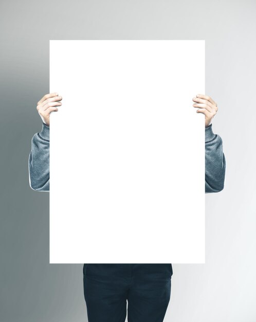 Businessman holding blank white banner